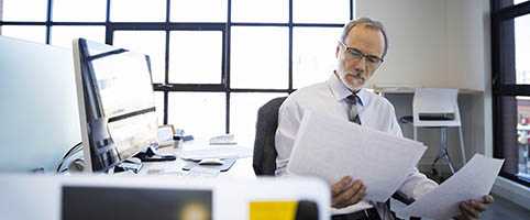 Business man reviewing plans | CNA Insurance