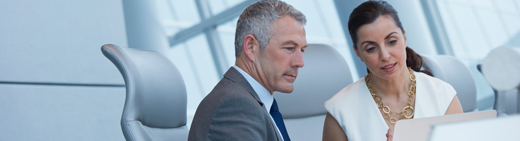 Business man and woman looking over a report | CNA Insurance