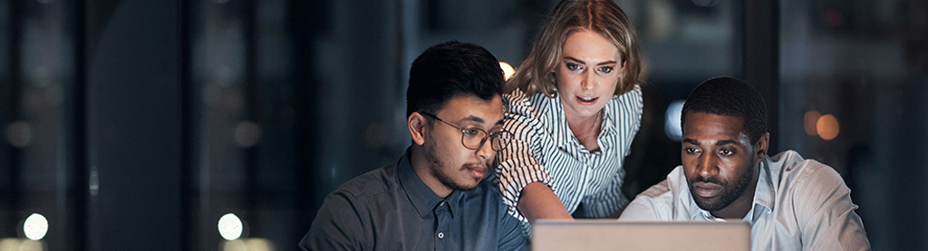 Team discussing insurtech over laptop in office | CNA Insurance