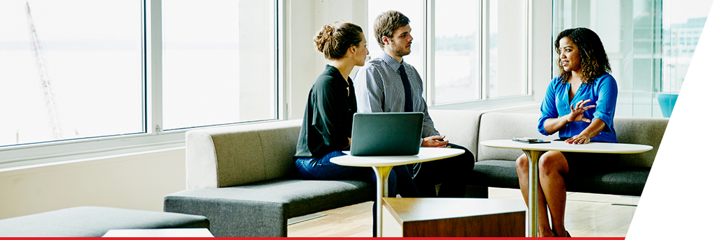 Three colleagues sitting in a meeting together