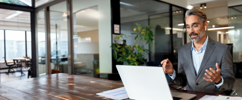 Man working in office with airpods | CNA Insurance