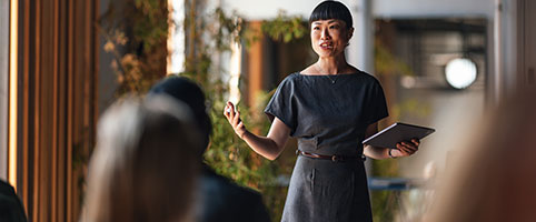 Woman presenting to colleagues in an office