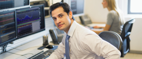 MAn sitting with computer in office | CNA Insurance