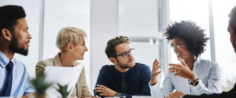 Colleagues talking together at a table
