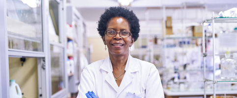 Female scientist standing in a lab with arms crossed
