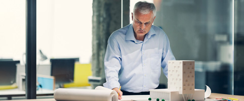 Architect looking over blueprints in an office