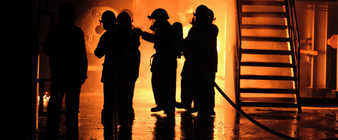 Firefighters putting out a fire in a building