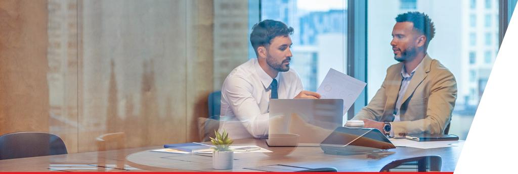 Two colleagues working together in an office conference room