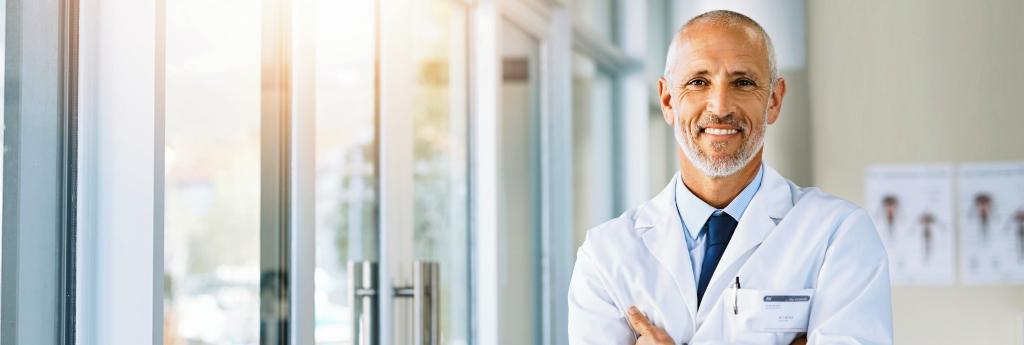 Doctor standing in an office with arms crossed