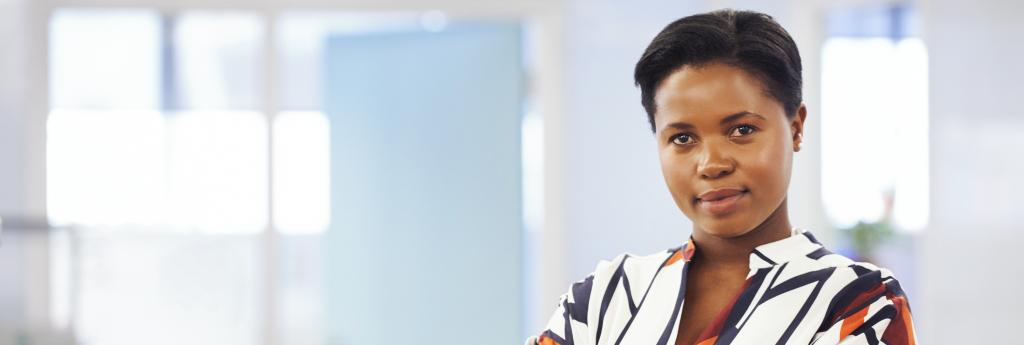Woman standing in an office hallway