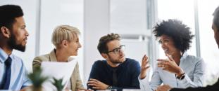 Colleagues talking together at a table
