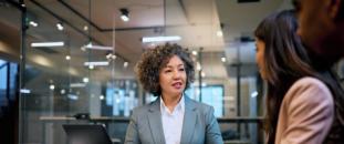 Colleagues sitting at a table in an office working together