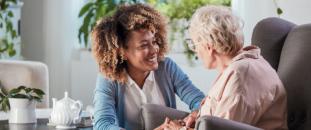 Nurse working with an elderly patient in an office