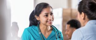 Nurse with a stethoscope talking with a patient in an office