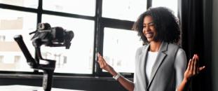 Woman in an office sitting in front of a camera