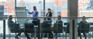 Colleagues presenting in a conference room