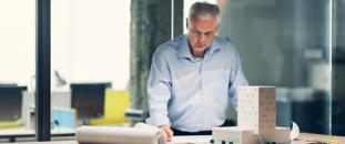 Architect looking over blueprints in an office