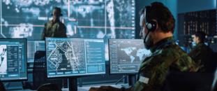 Man sitting in front of a monitor with a headset on