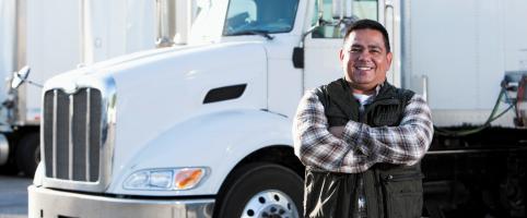 Truck driver in front of truck | CNA Insurance