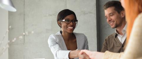 Colleagues shaking hands in an office