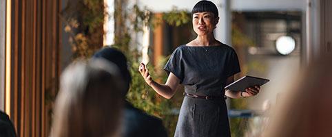 Woman presenting to colleagues in an office