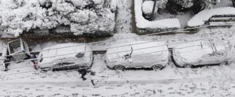 snow-covered-streets-and-cars-damaged-power-lines