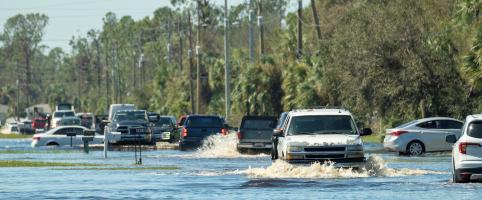 Cars on the road in flood waters