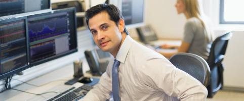 MAn sitting with computer in office | CNA Insurance