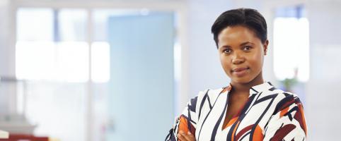 Woman standing in an office hallway